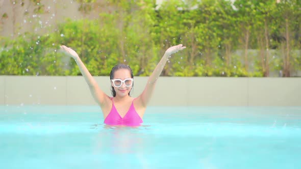 Young asian woman enjoy around outdoor swimming pool for leisure