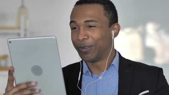 Close Up Of Casual AfroAmerican Businessman Doing Online Video Chat on Tablet