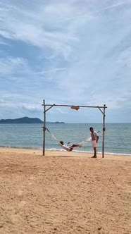 Men and Women Relaxing in Hammock on the Beach in Pattaya Thailand Ban Amphur Beach