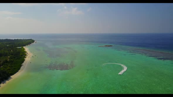 Aerial drone view nature of tranquil coastline beach adventure by blue green water with white sand b