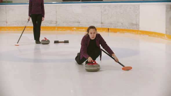 Curling Training in the Sport Complex - Woman Skating on the Ice