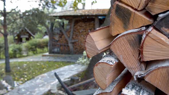 Firewood stacked in a woodpile outdoors in the village