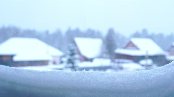 View From the Snow-covered Window on the Village Houses and the Forest