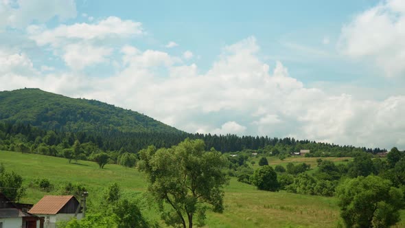 View From Window of Highspeed Train on Landscape of Beautiful Nature Wild Field and Mountains Forest