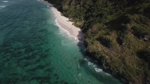 Aerial View of Tropical Beach with Azure Blue Water and Foaming Ocean Waves