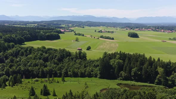 Idyllic bavarian summer landscape, filmed from above, panning right, in mountain range of the alps w