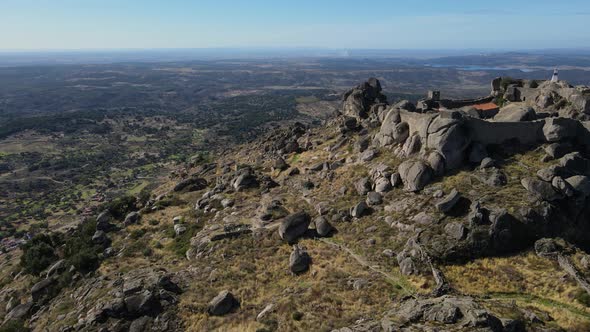 Monsanto castle ruins and surrounding landscape, Portugal. Aerial forward