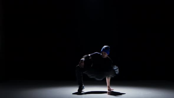 Dancer Man in Hat Dancing Breakdance on Black