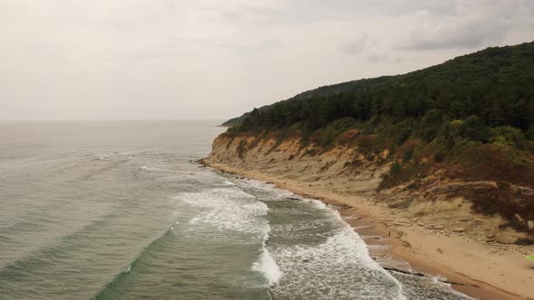 Aerial Drone Top View Over Ocean Black Sea Sand Beach Rocky Mountains Cliffs Dense Forest Bright