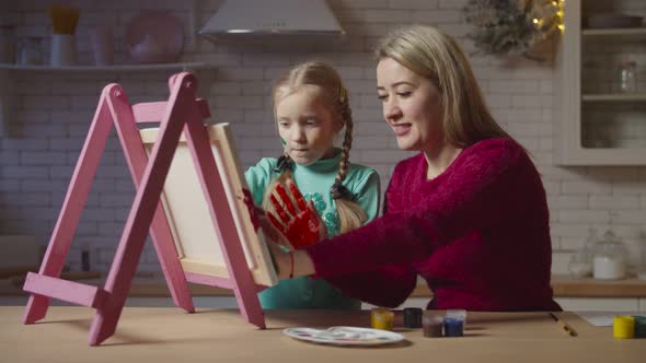 Carefree Mother and Child Painting with Hands