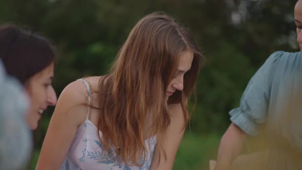 A Group of Young Women in Nature in the Park Hold a Master Class in Clay Modeling