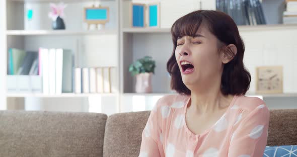 Asian young woman feeling itchy nose and sneezing 