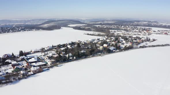 Aerial Drone Shot  Snowcovered Villages Fields and Forests in a Rural Area in Winter