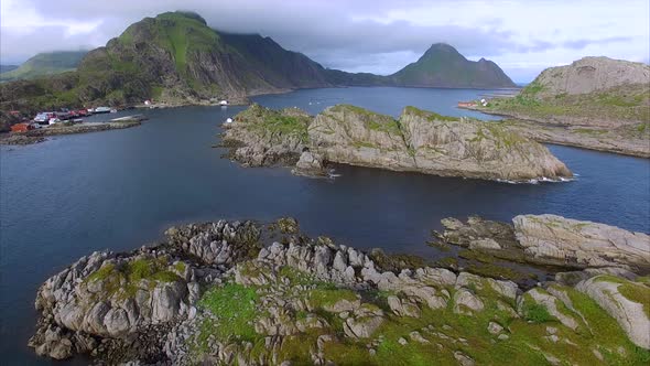 Flying above rocky islands on Lofoten islands in Norway near Mortsund