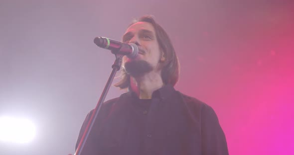 Expressive Singer Singing Into Microphone