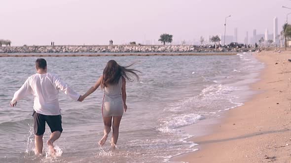 People Join Hands and Run Along Tropical Beach Slow Motion