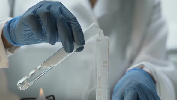 Lab Researcher Pouring Experimental Substance Into Tube, Chemistry Lesson