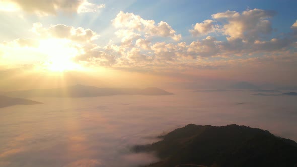 Aerial view from drone, Epic sunbeam over clouds mountains. 4K aerial shot on sunrise