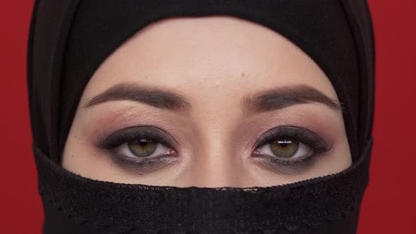 Extreme Close Up Portrait of Middle Eastern Woman with Smoky Eyes Looking on Camera in Traditional