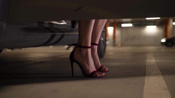 Feet of Woman in High Heels Getting Out of Car