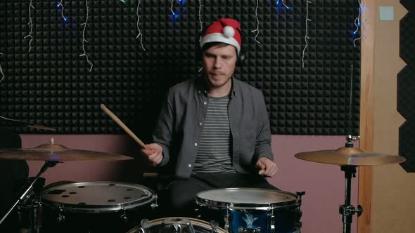 Santa Claus Man Sits Down to Play the Drum Set