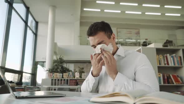 Sick Businessman with Temperature Works in Office and Wipes His Nose with a Napkin, Latinos Man