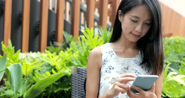 Woman working on cellphone at outdoor 