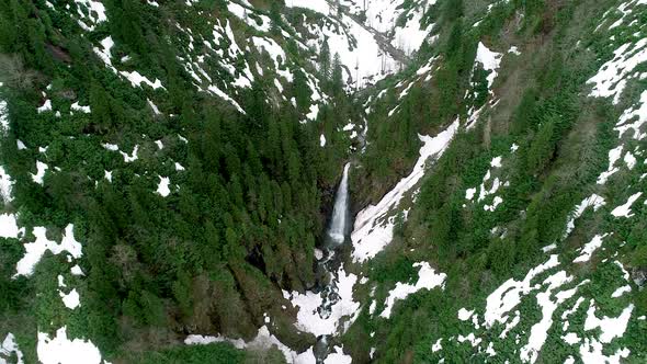 Flowing waterfall in snowy forest