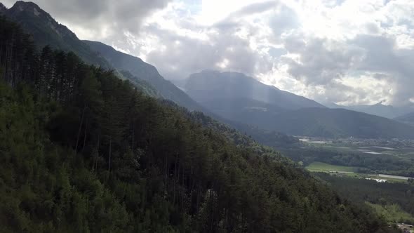 Aerial view of the mountains and forest in Borgo Valsugana in Trentino Italy with drone flying forwa