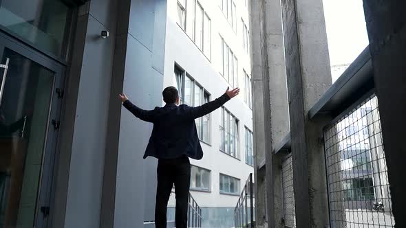 Successful businessman with arms up celebrating his victory