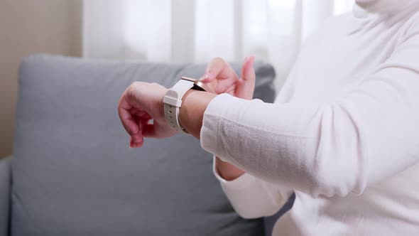 Technology online IOT concept. Close up shot of a woman hand who touch and scrolling on a smartwatch