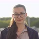 Closeup portrait of smiling brunette businesswoman wearing glasses looking directly at the camera - VideoHive Item for Sale