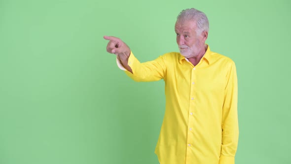 Happy Senior Bearded Businessman Touching Something and Giving Thumbs Up