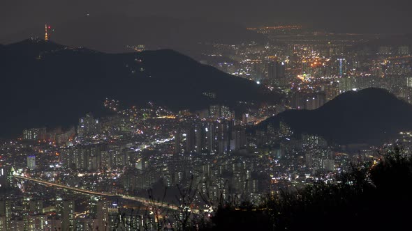 Timelapse Busan City with Buildings By Hills at Bright Night