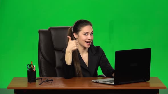 Business Woman Working on a Laptop Smiling Joyfully and Showing Thumbs Up, Gesture Like. Green