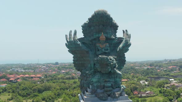 Front Rotating Aerial View of Majestic Copper and Brass Garuda Wisnu Kencana Statue in Bali