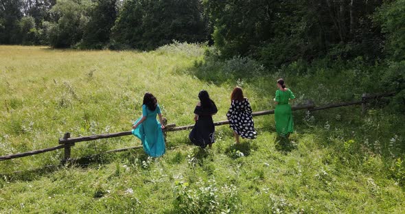 Young Girls Rest And Rejoice In The Meadow