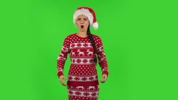 Sweety Girl in Santa Claus Hat Is Frustrated Saying Oh My God and Being Shocked. Green Screen