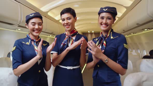 Cabin Crew Clapping Hands in Airplane