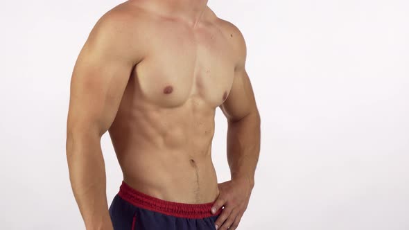 Muscular Man with Perfect Abs Flexing His Muscles Isolated