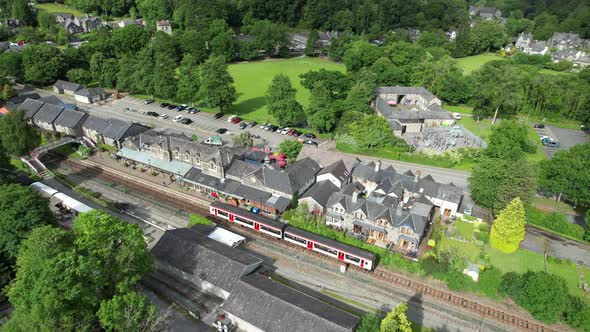 Betws y coed railway station train leaving platform north Wales UK drone aerial view