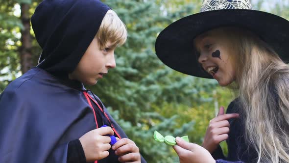 Children in Halloween Costumes Arguing Who Will Collect More Candies