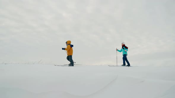 A Boy and a Girl are Skiing