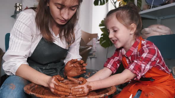 Ceramic Artist Teaching Girl How To Create Ceramics