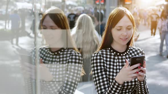 Beautiful Female Person Using Smart Phone in the City