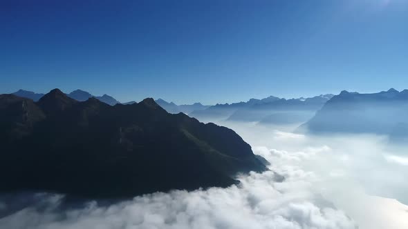 Aerial view of low lowing clouds covering the mountain peaks of the Swiss Alps, Switzerland (3)