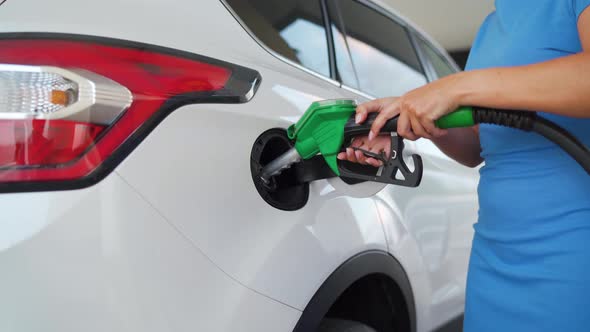 Woman Pulls Out a Refueling Gun From a Car Tank After Finishing Refueling