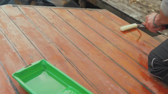 Rolling varnish roof planks of wooden boat wheelhouse cabin