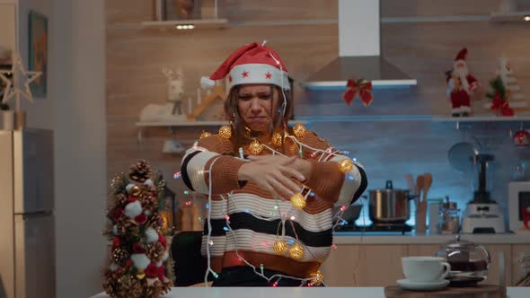 Woman Decorating Kitchen with Festive Ornaments