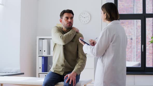 Man Patient with Sore Neck and Doctor at Hospital